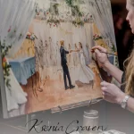Live wedding painter Ksenia Craven adding details to a custom canvas painting of a bride and groom’s first dance.