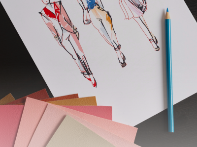 Three stylized hand-drawn fashion illustrations on paper with leather swatches and a blue pencil.